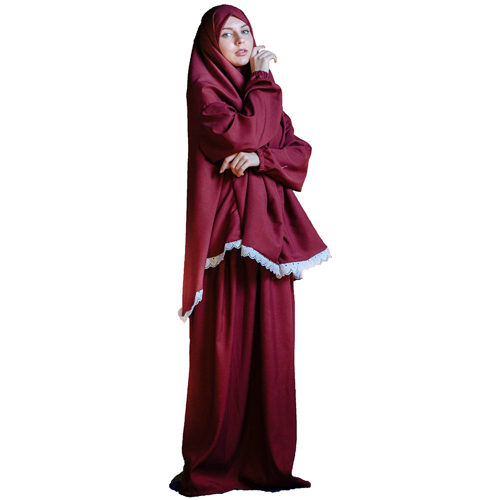 A woman wearing a solid color microfiber prayer dress with long sleeves, designed for Muslim prayer attire.