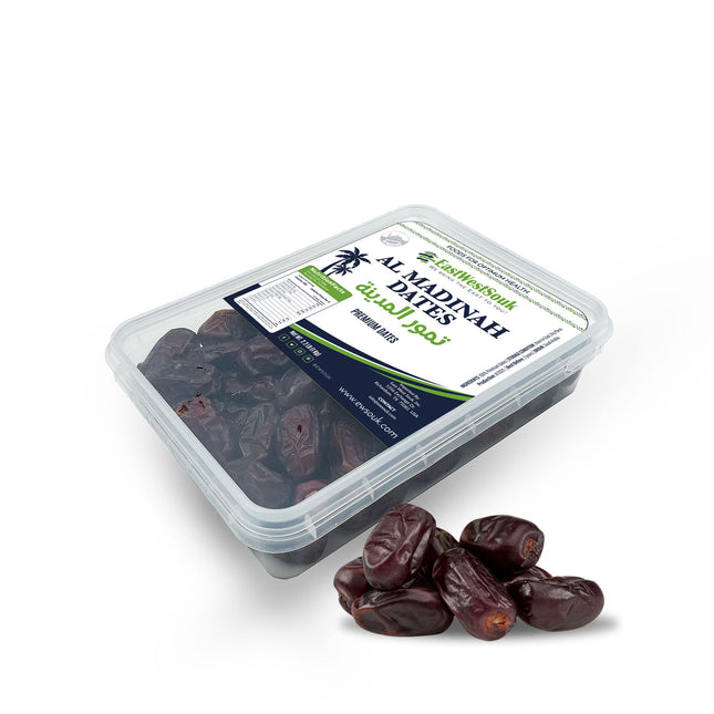 Container of Al Madinah Dates with a few dates displayed in front on a white background